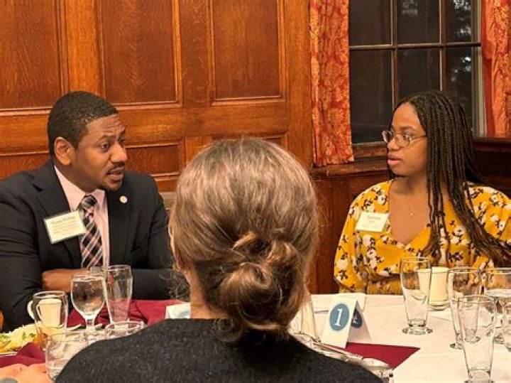 Where should the wife sit at the dinner table?